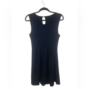 Monteau navy dress with an A line skirt and pleats. High necked w/ key hole.